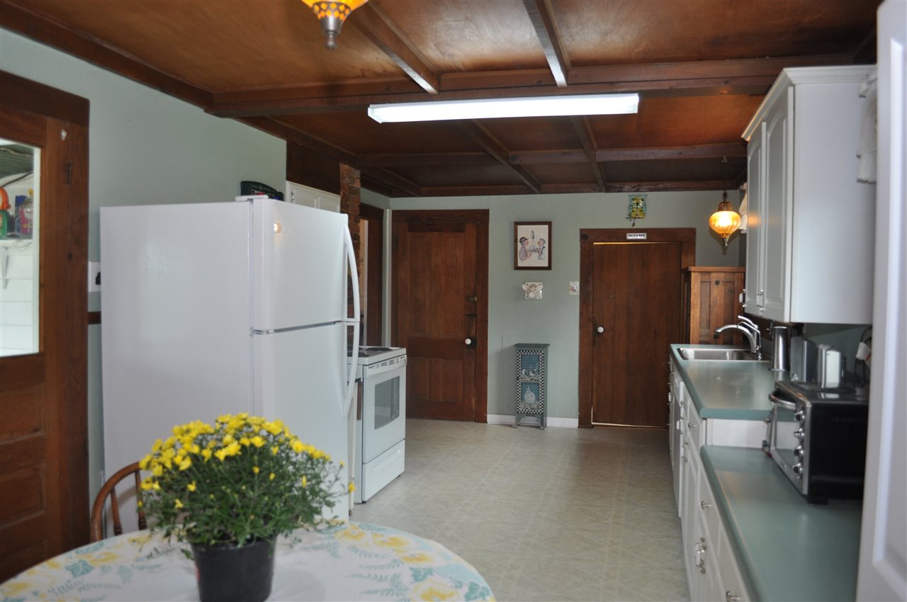 3994 Spring Hill Road Staunton, VA 24401 - Photo 23 of 41 a kitchen with a refrigerator and a chandelier