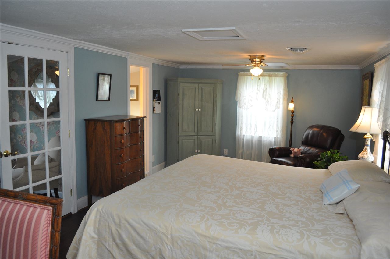 3994 Spring Hill Road Staunton, VA 24401 - Photo 32 of 41 a bedroom with a large bed and a chandelier