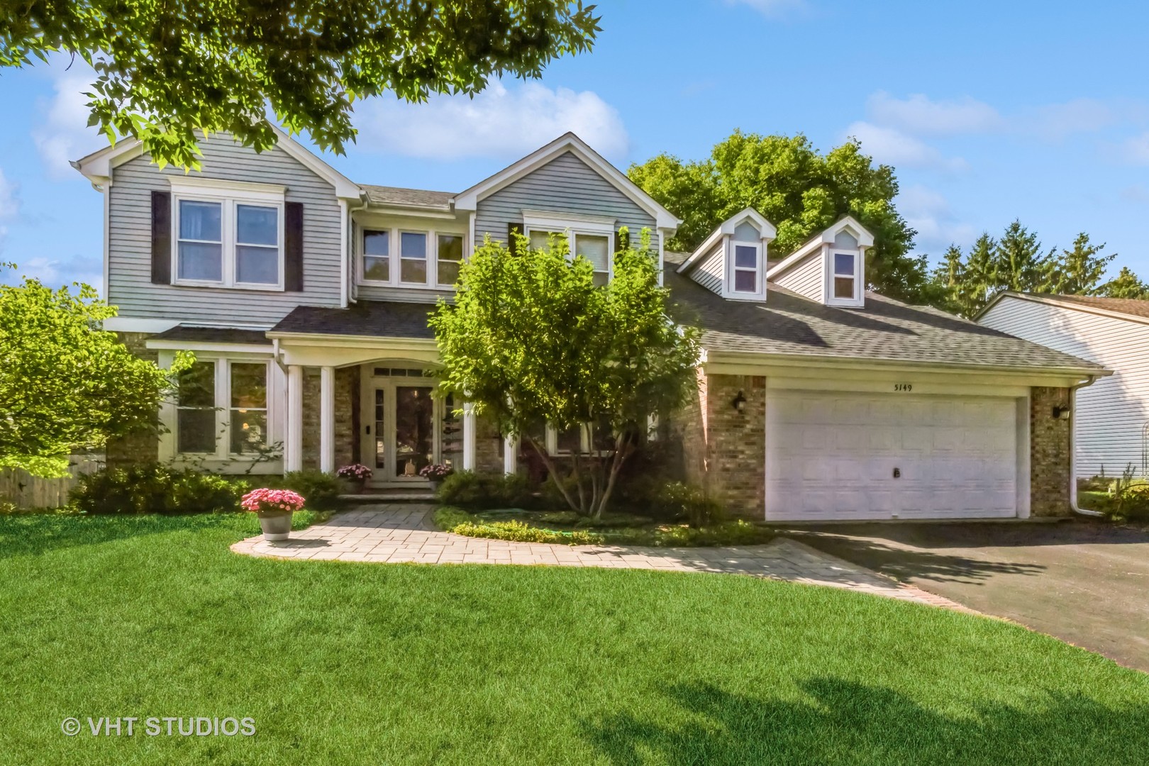 a front view of house with yard and green space