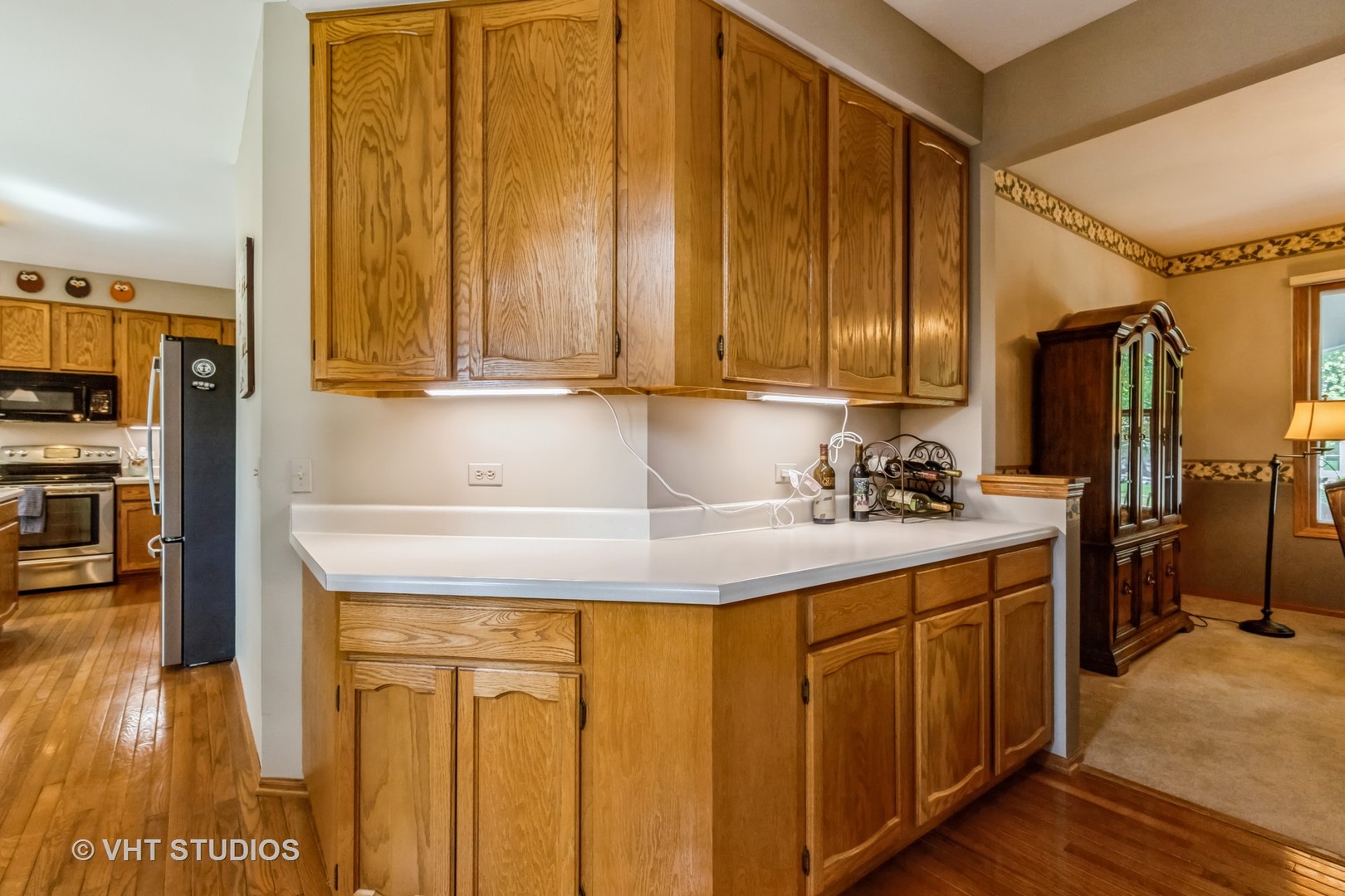 5149 Conifer Lane Gurnee, IL 60031 - Photo 6 of 18 a kitchen with stainless steel appliances granite countertop a sink a stove and a wooden cabinets