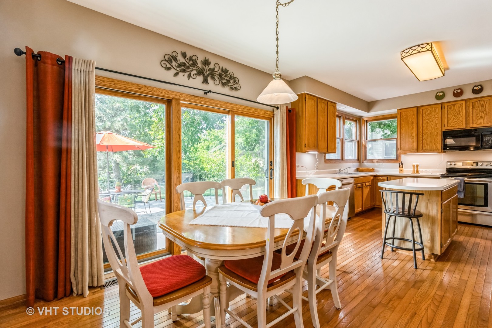 5149 Conifer Lane Gurnee, IL 60031 - Photo 7 of 18 a dining room with furniture a chandelier and wooden floor
