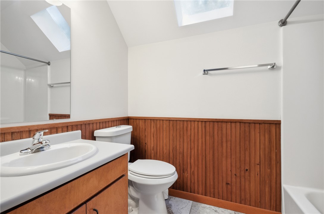 1298 Carradine Road Seneca, SC 29678 - Photo 28 of 43 A skylight brightens this bath, highlighting wood paneling and a practical vanity.