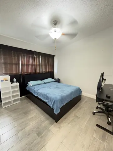 a bedroom with a bed and a painting on the wall