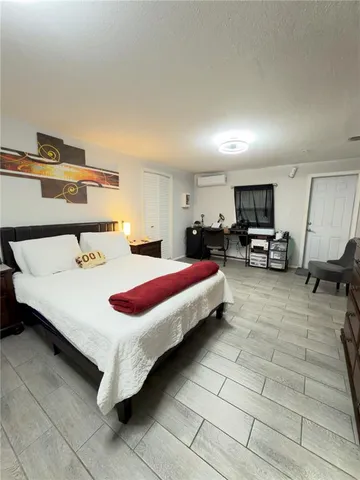 a bedroom with a bed and window