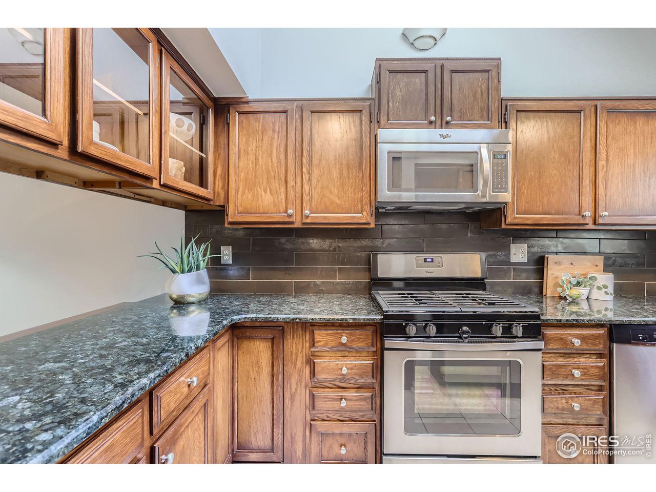 3075 Edison Court Boulder, CO 80301 - Photo 11 of 28 a kitchen with stainless steel appliances granite countertop a stove a sink and a microwave