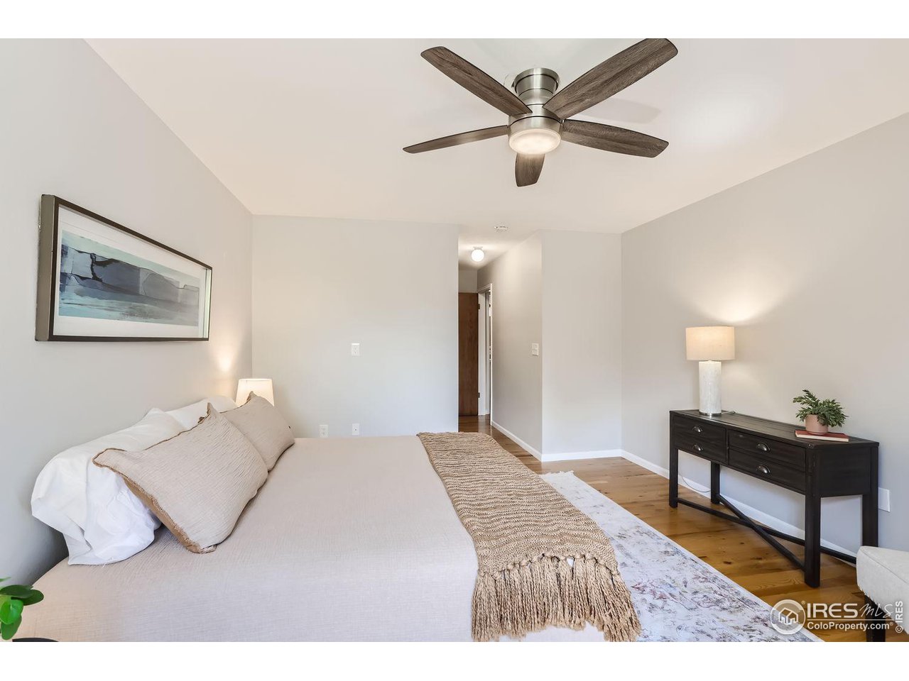 3075 Edison Court Boulder, CO 80301 - Photo 13 of 28 a bedroom with a bed and a painting on the wall