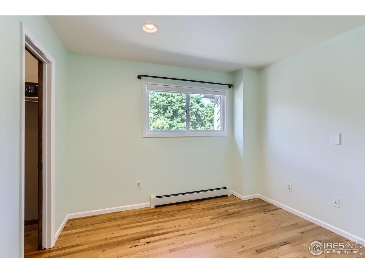 3075 Edison Court Boulder, CO 80301 - Photo 17 of 28 an empty room with wooden floor and windows