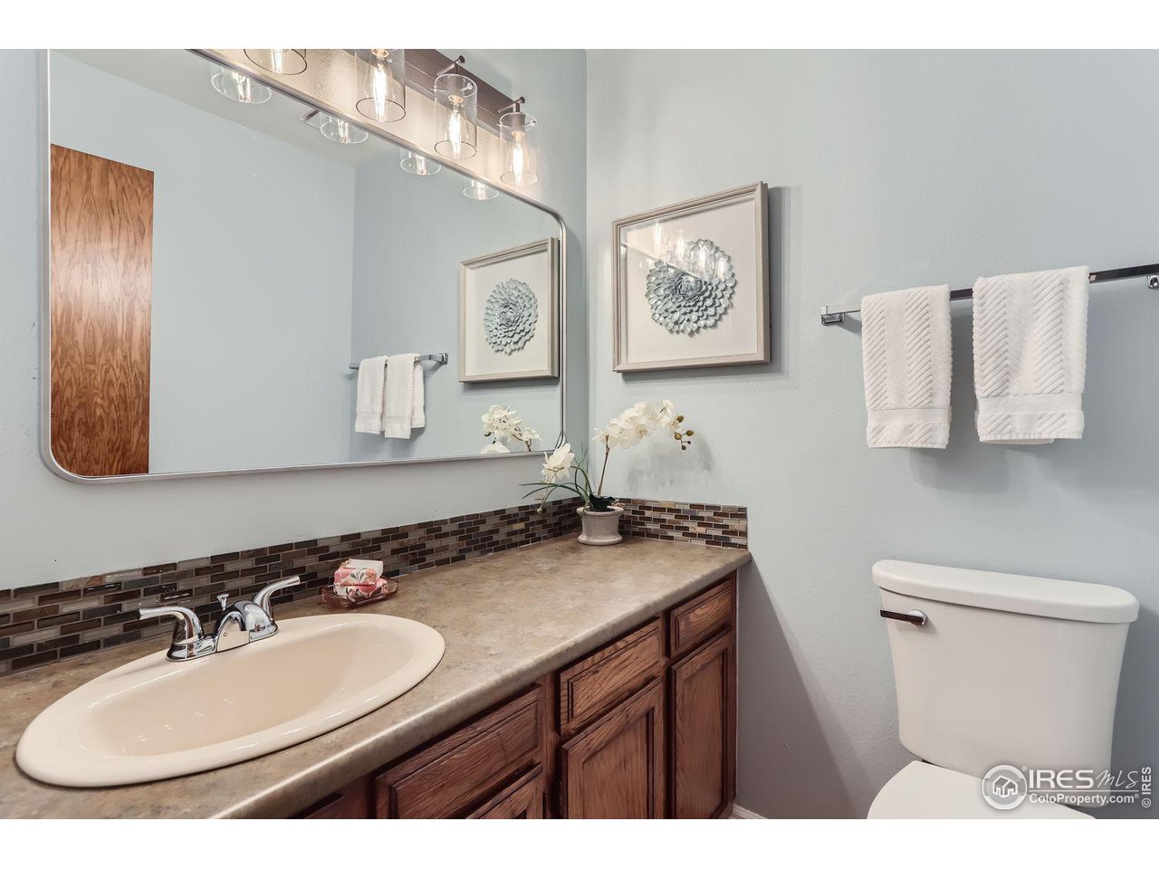 3075 Edison Court Boulder, CO 80301 - Photo 19 of 28 a bathroom with a sink double vanity and a mirror