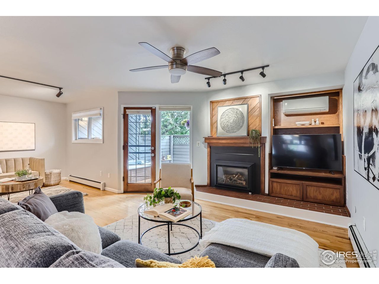 3075 Edison Court Boulder, CO 80301 - Photo 5 of 28 a living room with furniture a fireplace and a flat screen tv