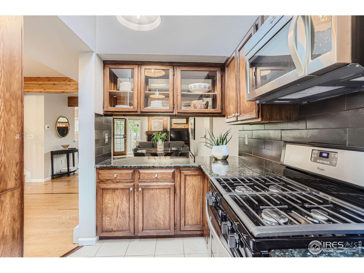 3075 Edison Court Boulder, CO 80301 - Photo 8 of 28 a kitchen with stainless steel appliances granite countertop a stove and a microwave
