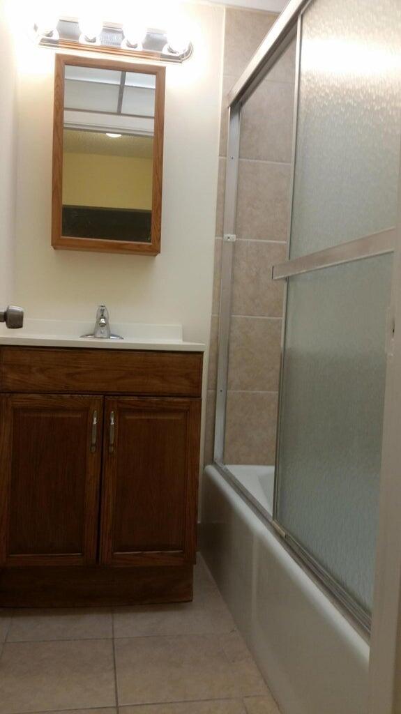 642 Northwest 13th Street, Unit 24 Boca Raton, FL 33486 - Photo 7 of 9 a bathroom with a sink and a mirror