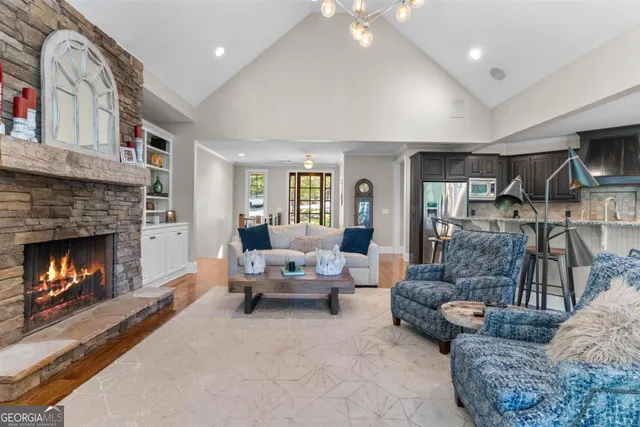 a dining room with furniture a chandelier and wooden floor
