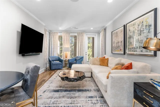 a room with wooden floor and a chandelier