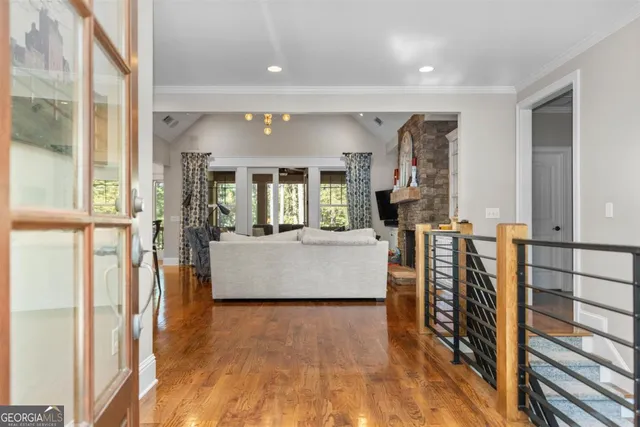 a kitchen with stainless steel appliances kitchen island granite countertop a stove top oven a sink a dining table and chairs