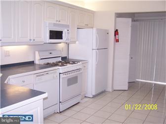891 Morefield Road Philadelphia, PA 19115 - Photo 8 of 12 a white refrigerator freezer and a stove sitting inside of a kitchen with granite countertop stainless steel appliances