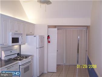 891 Morefield Road Philadelphia, PA 19115 - Photo 10 of 12 a kitchen with a stove and a refrigerator