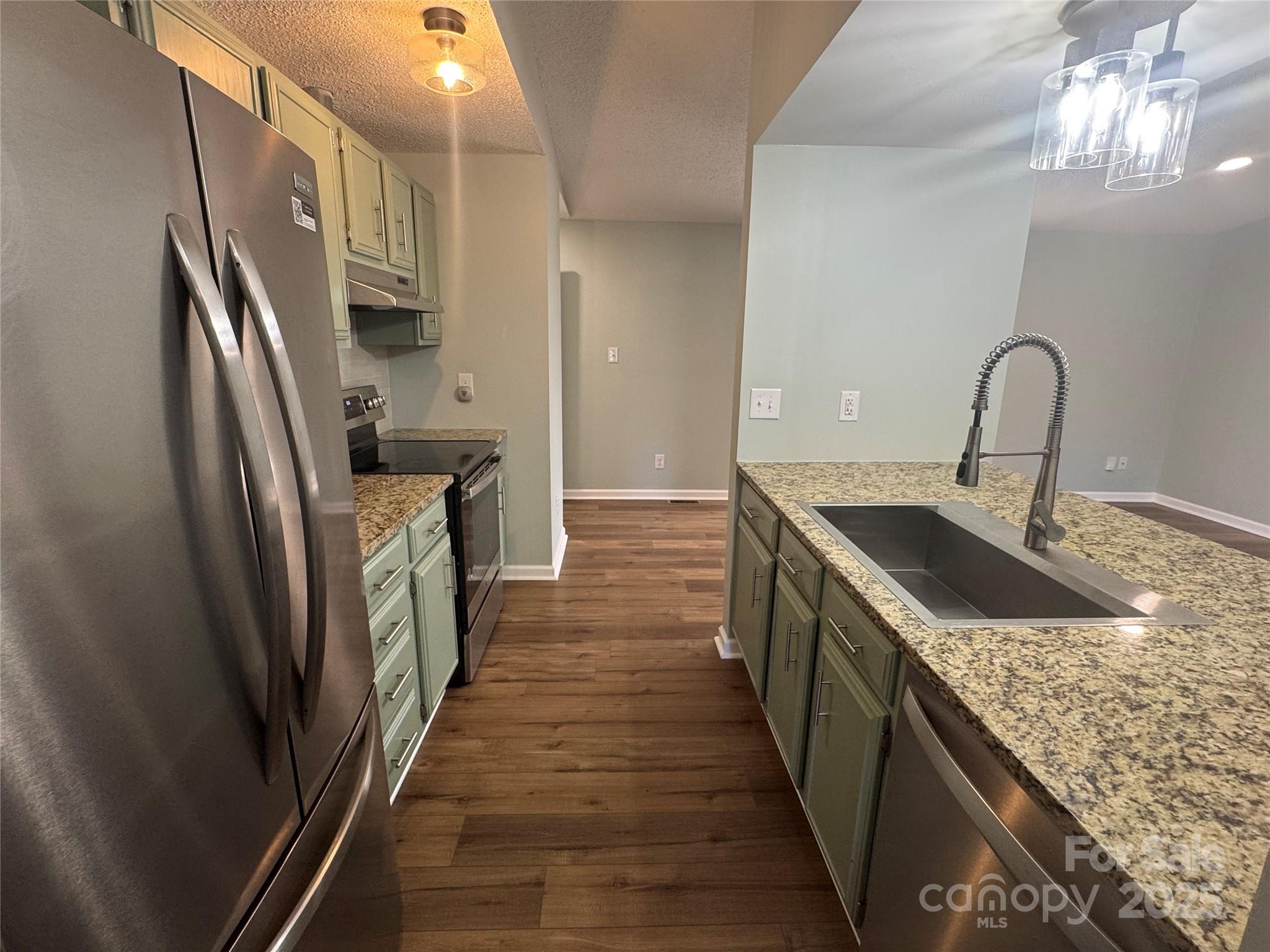 7939 Holly Hill Road Charlotte, NC 28227 - Photo 14 of 38 a kitchen with granite countertop a sink and stove