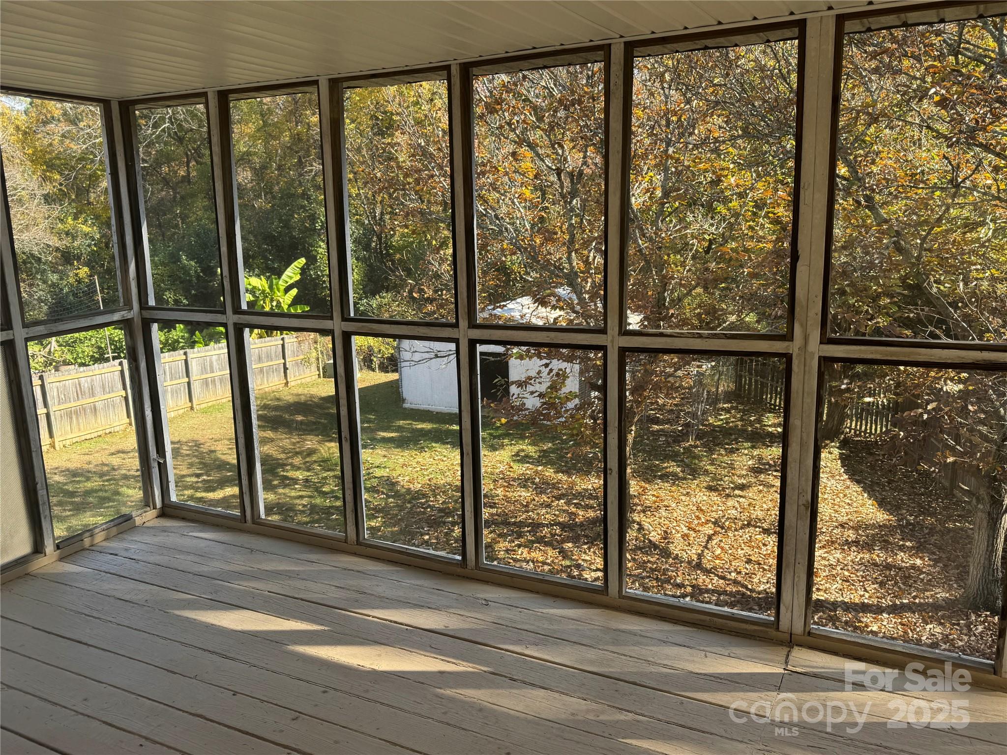 7939 Holly Hill Road Charlotte, NC 28227 - Photo 18 of 38 a view of an empty room with wooden floor and a window