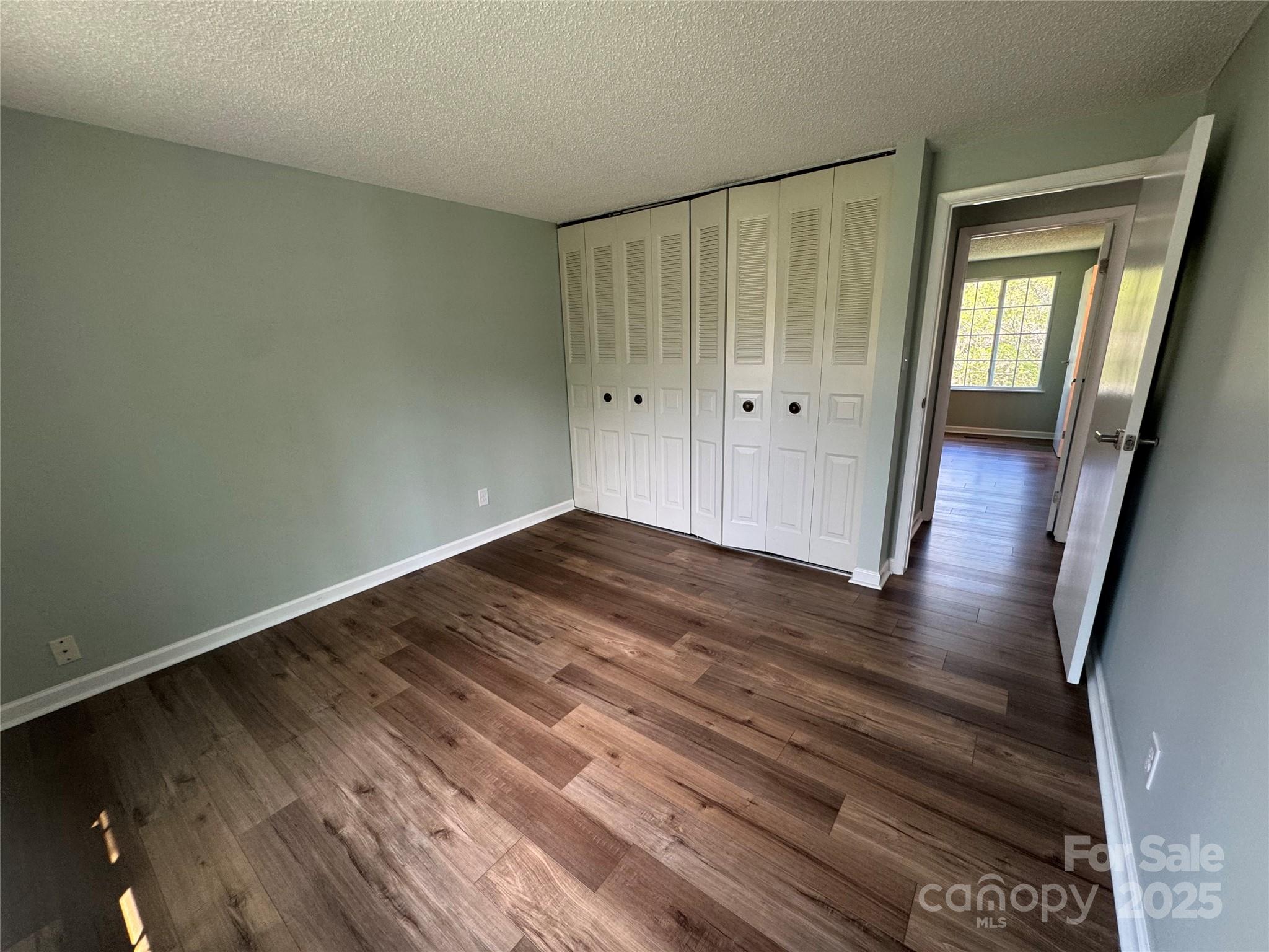7939 Holly Hill Road Charlotte, NC 28227 - Photo 22 of 38 a view of a room with wooden floor and window