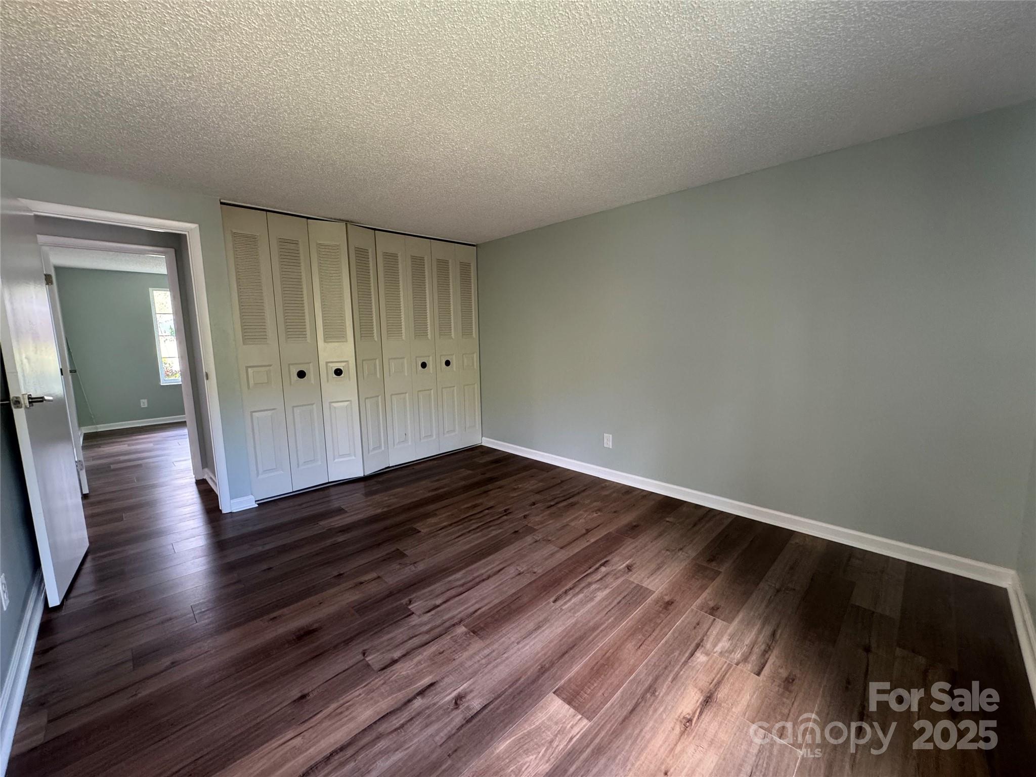 7939 Holly Hill Road Charlotte, NC 28227 - Photo 25 of 38 a view of a room with wooden floor