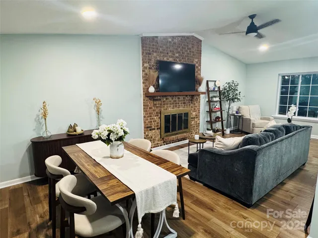 a view of a dining room with furniture and a fireplace