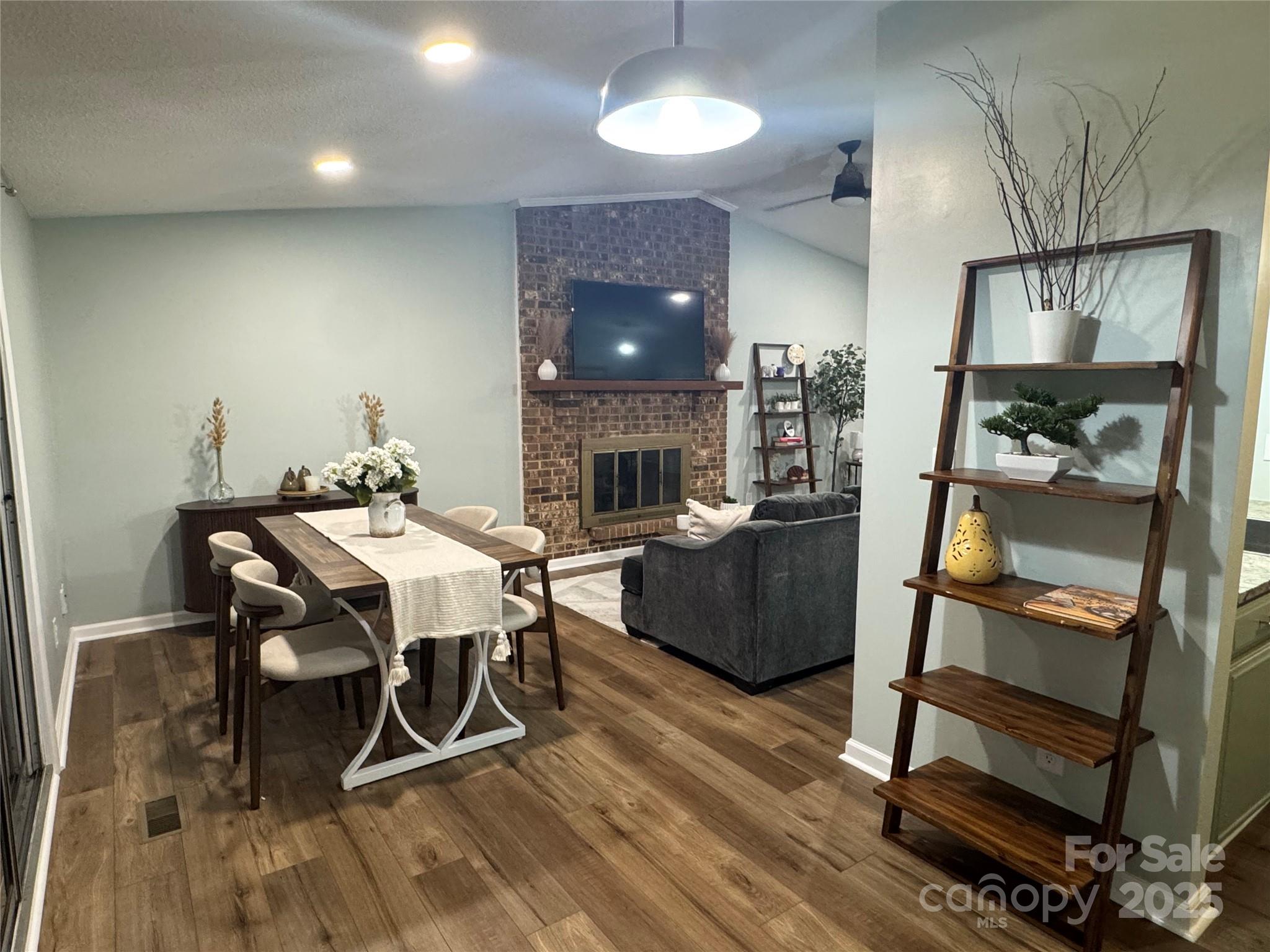 7939 Holly Hill Road Charlotte, NC 28227 - Photo 9 of 38 a view of a dining room with furniture and a fireplace