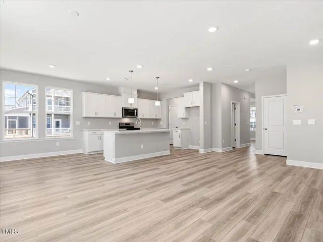 a kitchen with stainless steel appliances granite countertop a stove a sink and a white cabinets