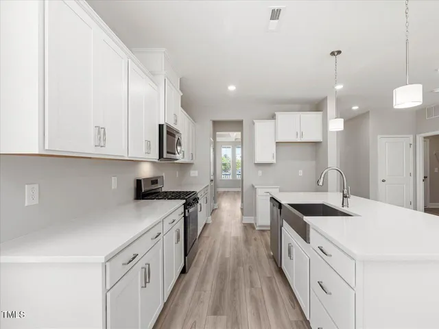 a view of a hallway with wooden floor and closet