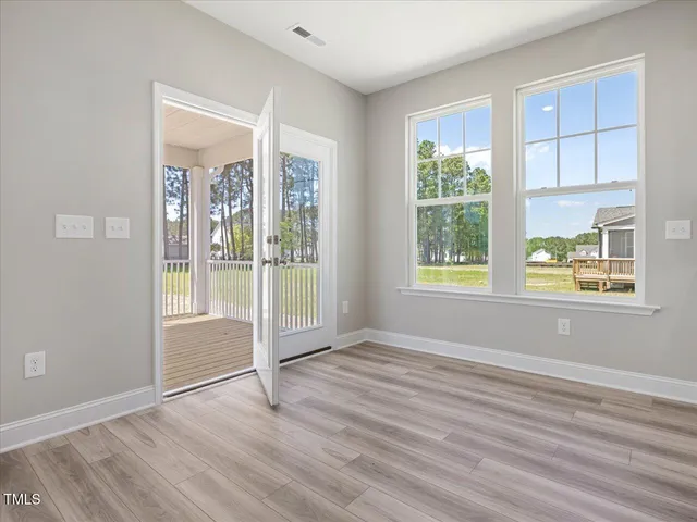 a view of a house with a yard and wooden fence