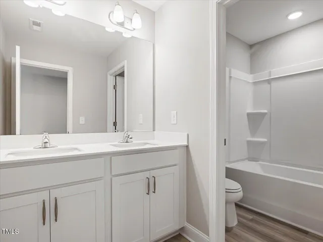 a view of an empty room and wooden floor