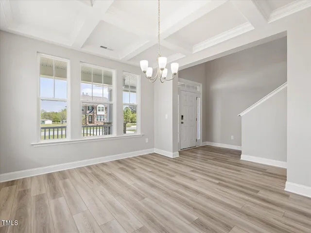 a view of a room with wooden floor and windows