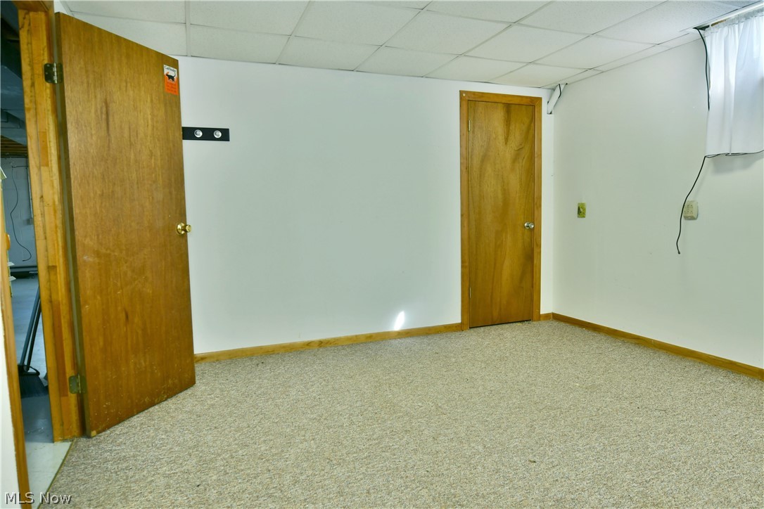 6570 Spencer Clark Road Fowler, OH 44418 - Photo 35 of 49 Carpeted spare room featuring a drop ceiling