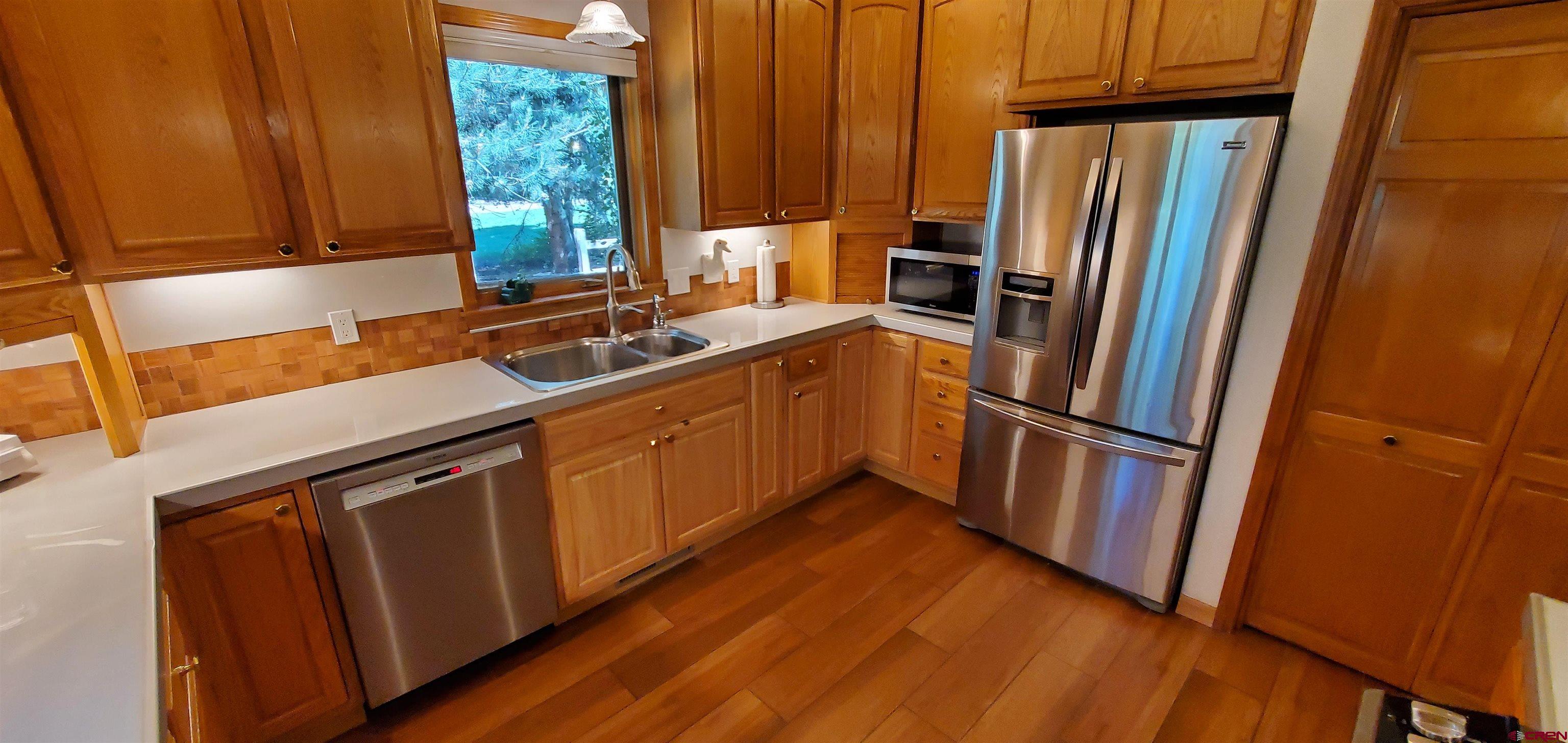 370 Red Rock Road Durango, CO 81301 - Photo 13 of 25 a kitchen with sink a refrigerator and a window
