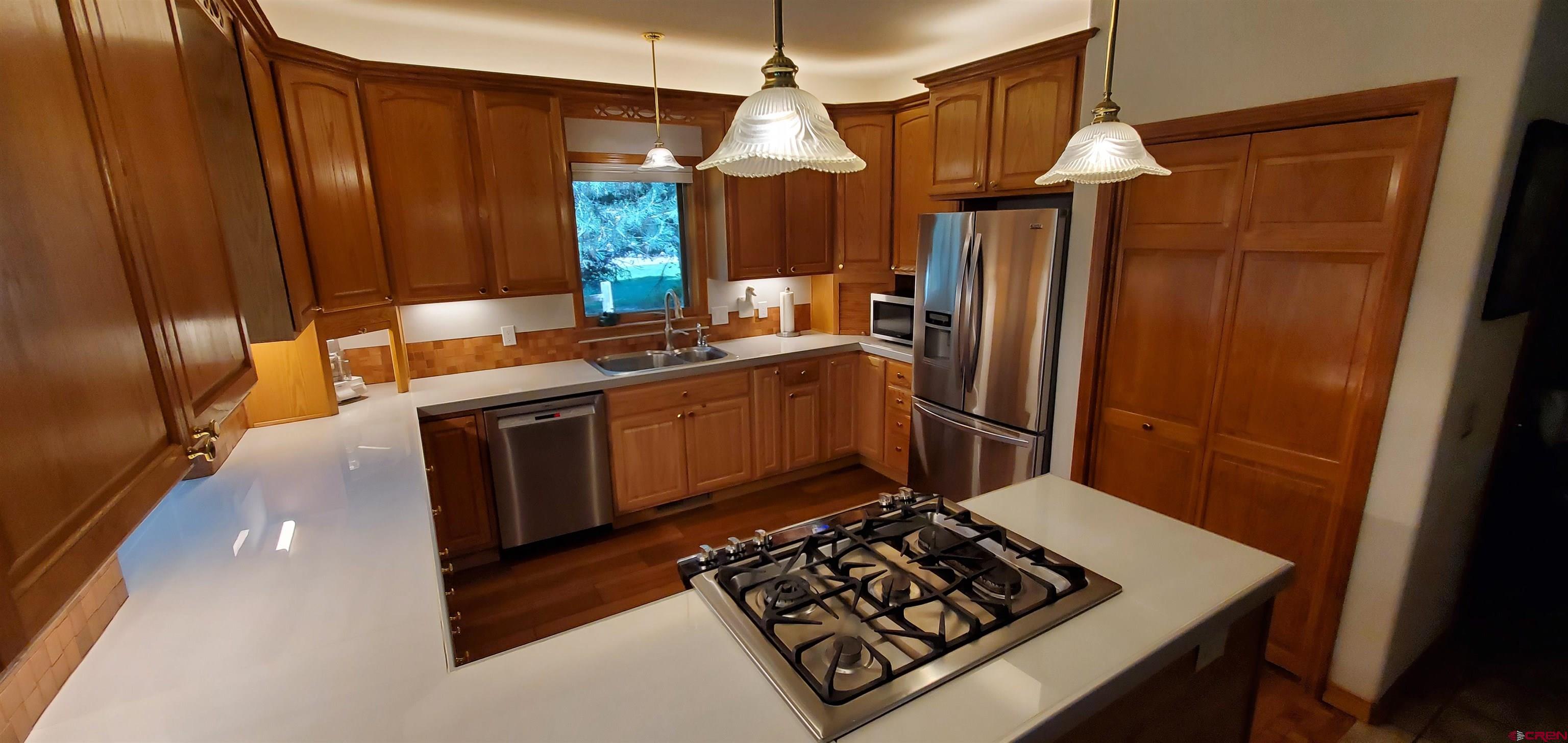 370 Red Rock Road Durango, CO 81301 - Photo 15 of 25 a kitchen with stainless steel appliances granite countertop a sink stove and refrigerator