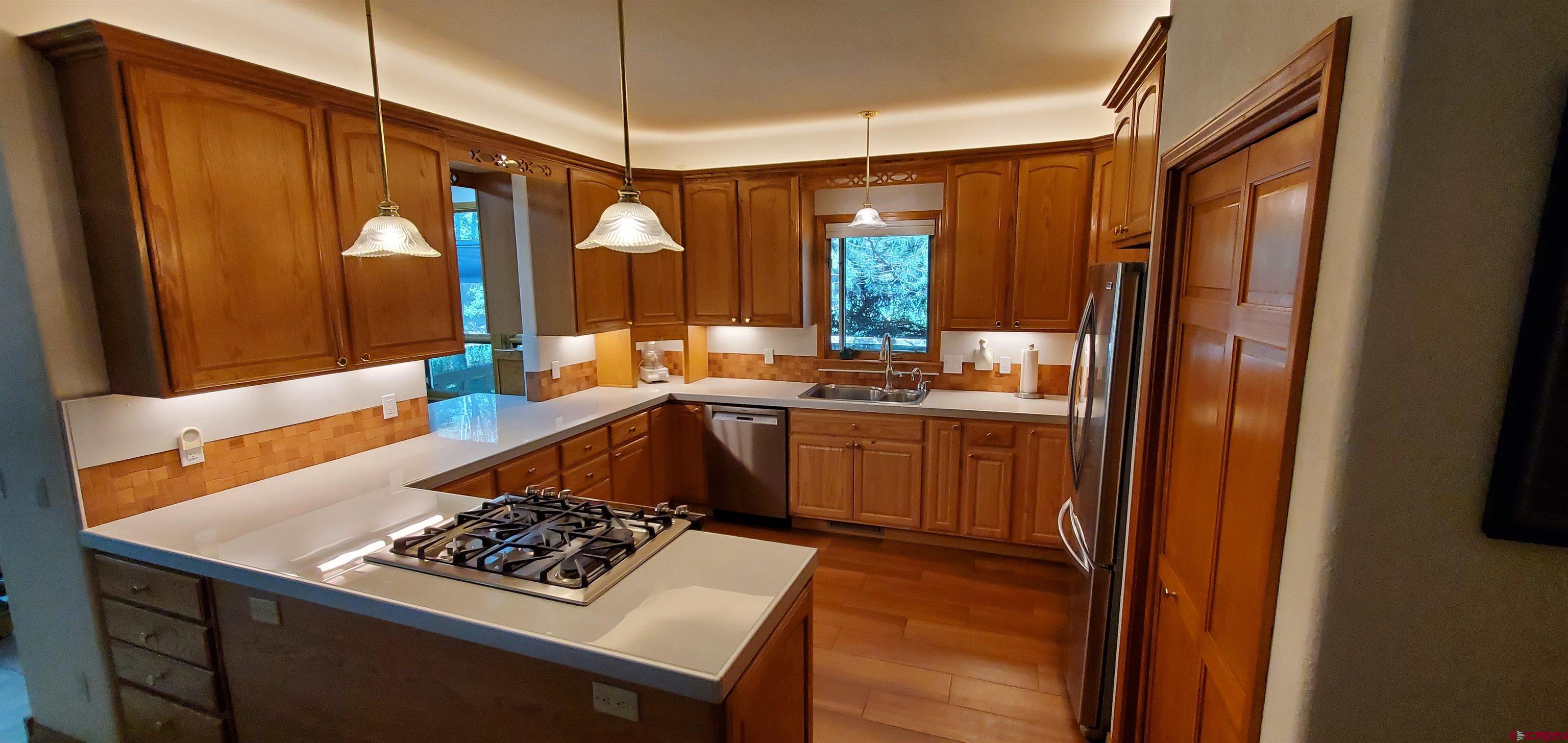 370 Red Rock Road Durango, CO 81301 - Photo 16 of 25 a kitchen view with a sink stove and refrigerator