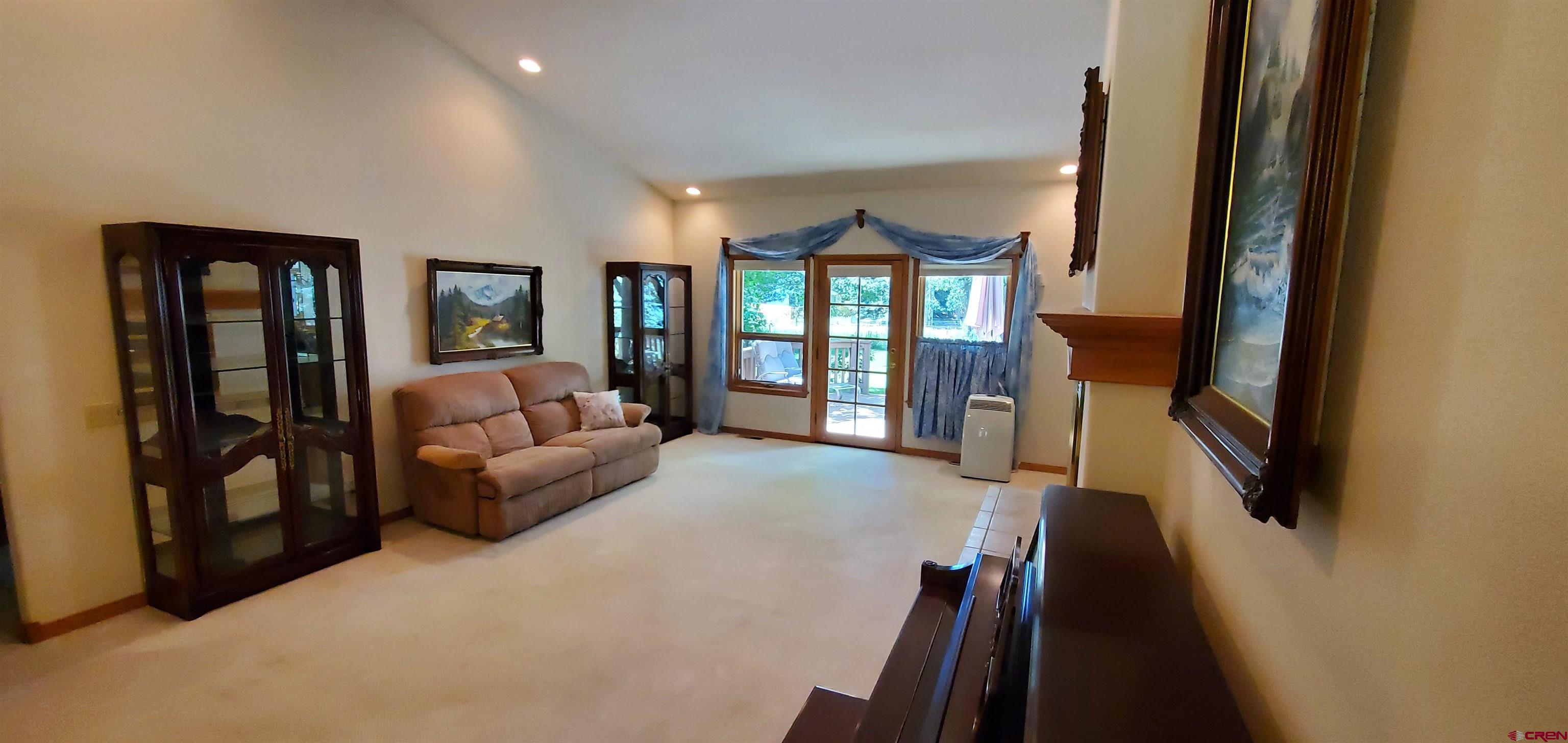 370 Red Rock Road Durango, CO 81301 - Photo 19 of 25 a living room with furniture and a flat screen tv
