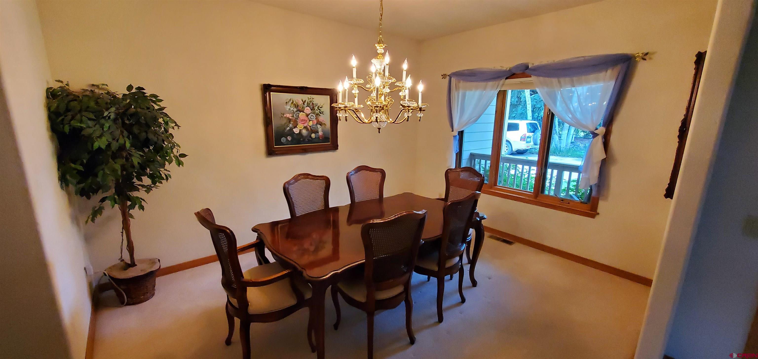 370 Red Rock Road Durango, CO 81301 - Photo 25 of 25 a view of a dining room with furniture and chandelier