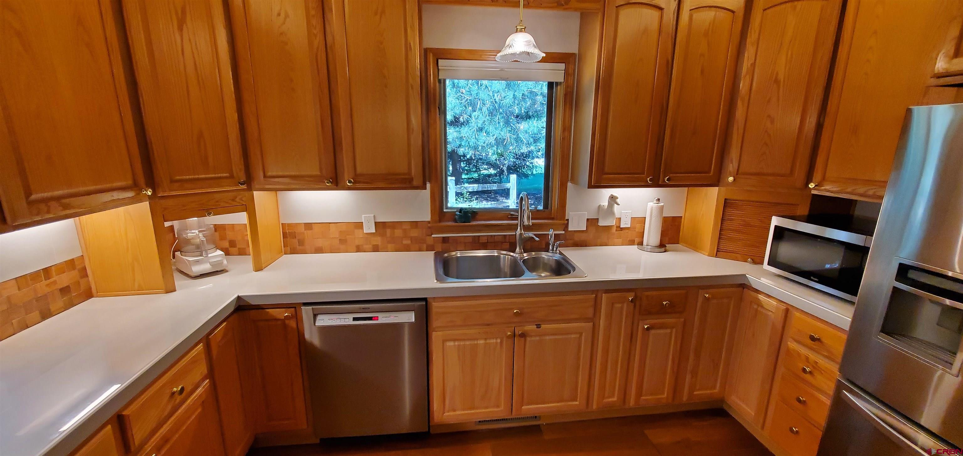 370 Red Rock Road Durango, CO 81301 - Photo 6 of 25 a kitchen with a sink cabinets and window
