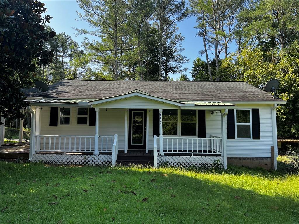 2225 Upper Burris Road Canton, GA 30114 - Photo 1 of 1 a view of a house with a yard and a large tree