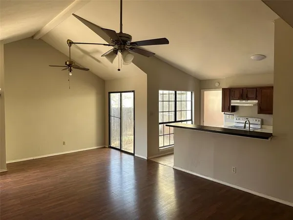 a view of a kitchen with a sink and cabinet with wooden floor