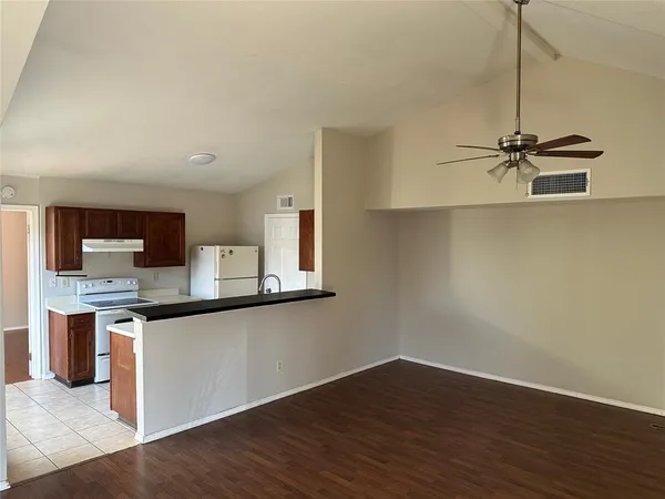 a view of a kitchen with wooden floor and a sink