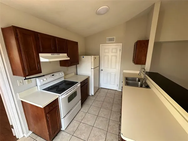 a kitchen with a stove and a refrigerator