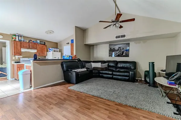 a kitchen with a refrigerator and a stove top oven
