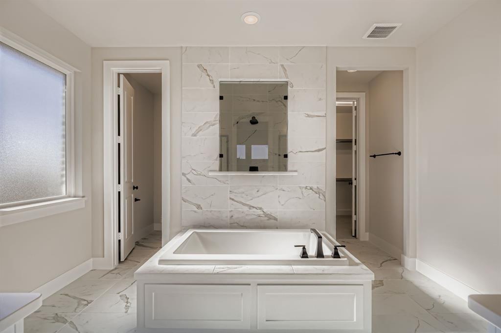2118 Newhall Road Celina, TX 75009 - Photo 17 of 29 Bathroom with a bath, light marble finish flooring, a marble finish shower, a walk in closet, and recessed lighting