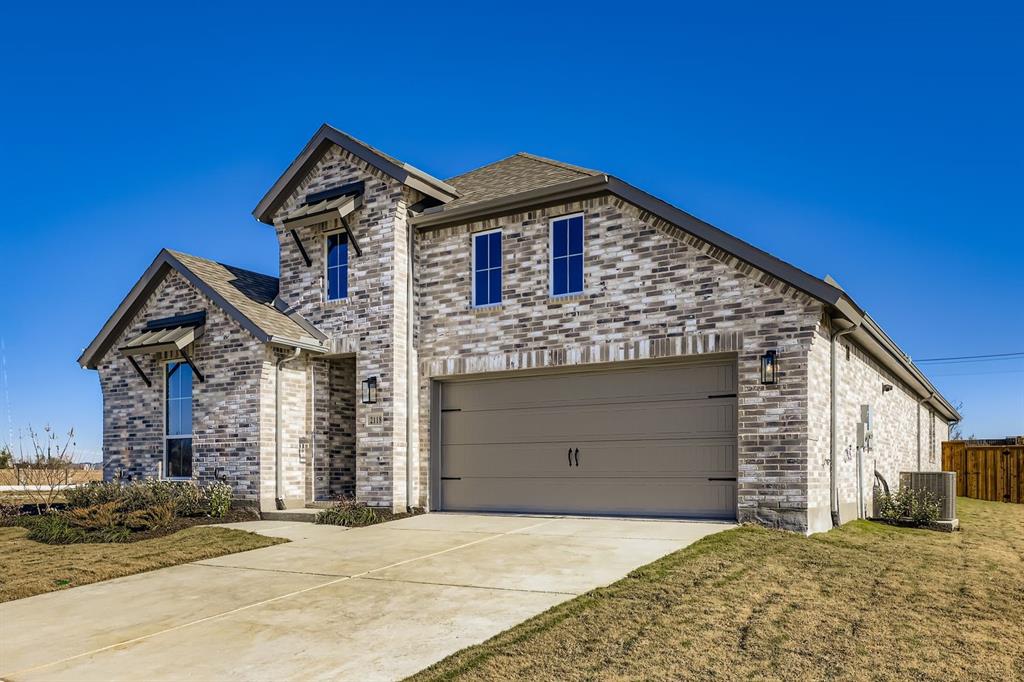 2118 Newhall Road Celina, TX 75009 - Photo 2 of 29 View of front facade with a garage, concrete driveway, brick siding, and a shingled roof
