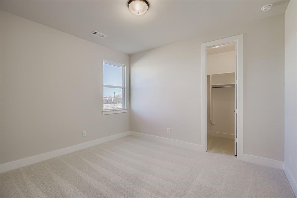 2118 Newhall Road Celina, TX 75009 - Photo 21 of 29 Unfurnished bedroom with light carpet and a spacious closet