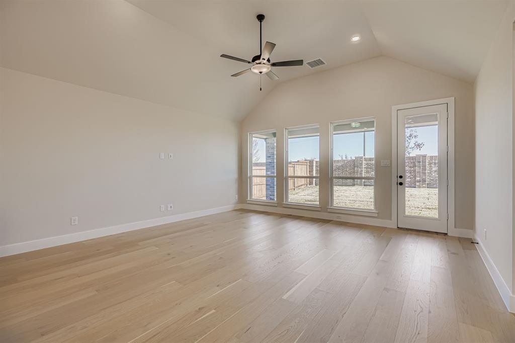 2118 Newhall Road Celina, TX 75009 - Photo 5 of 29 Unfurnished living room featuring light wood finished floors, ceiling fan, lofted ceiling, and recessed lighting