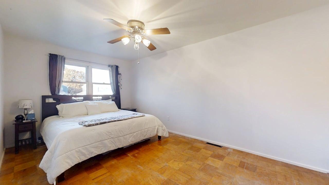 1507 Golfview Road, Unit 1507 Rantoul, IL 61866 - Photo 11 of 24 a bedroom with a bed and a chandelier