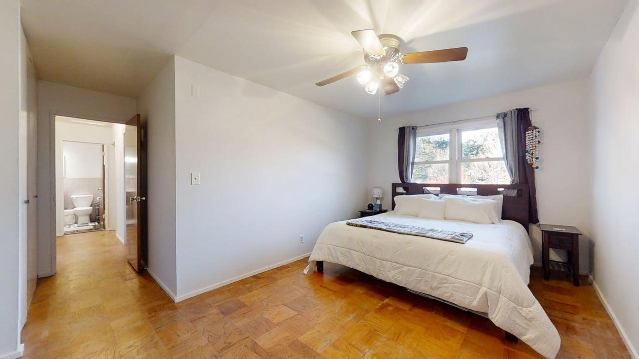 1507 Golfview Road, Unit 1507 Rantoul, IL 61866 - Photo 12 of 24 a bedroom with a bed and a chandelier