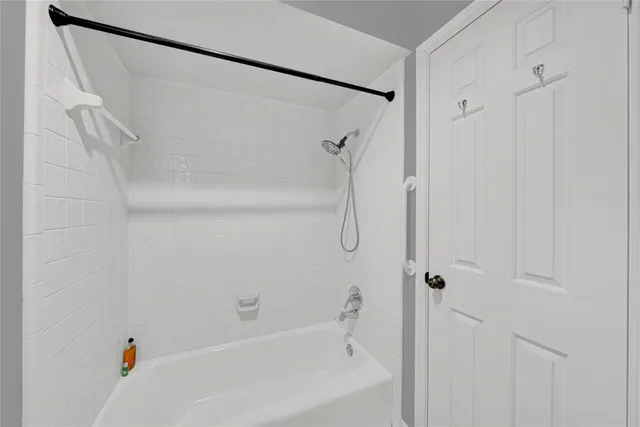 a bathroom with a shower and a bath tub